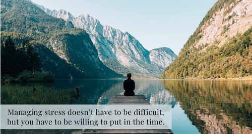 Man sitting on dock water mountains